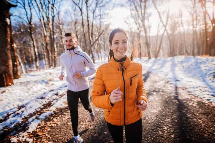 1196192464 featured image Two people jogging in a snowy forest path