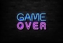 "Game Over" neon sign on brick wall.