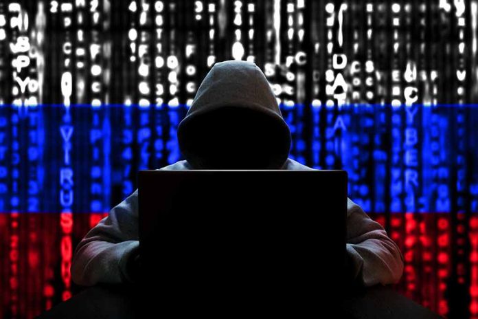 1654709008 featured image Hacker in hoodie with Russian flag background and code.