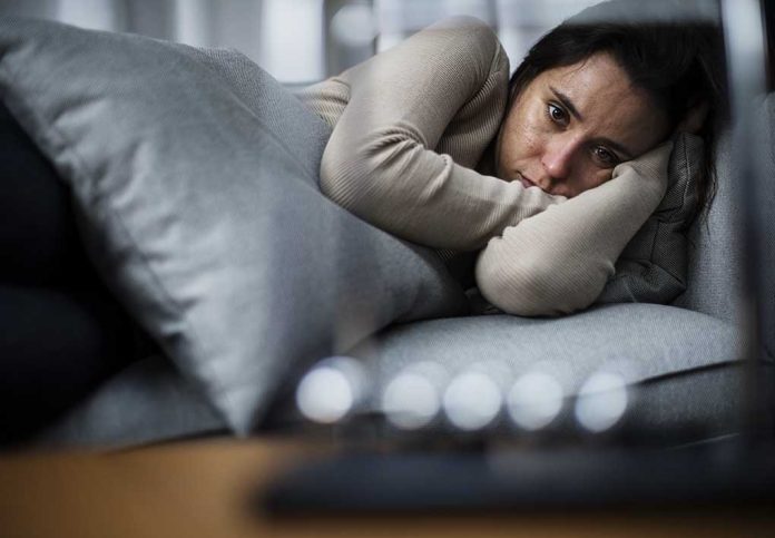 735101695 featured image Person lying on couch looking sad and pensive