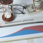 Retirement planner graph with money glasses hourglass