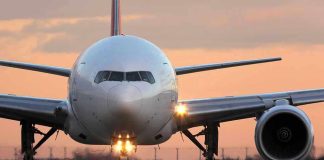 Airplane on runway during sunset