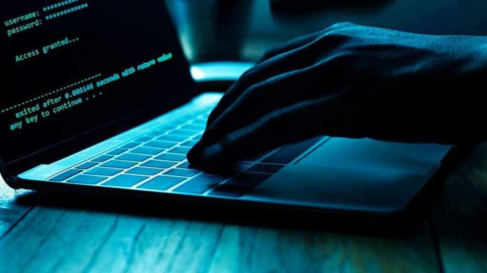 1166453734 Hand typing on laptop with code on screen