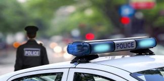 Police car and officer on a city street.
