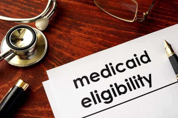 640488934 Stethoscope pen document about Medicaid eligibility on table