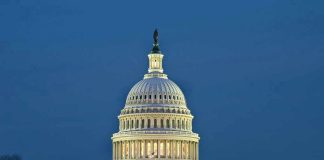 U.S. Capitol building illuminated at dusk.