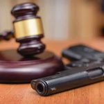 Biden’s-ERA Gun Rule ERADICATED Gavel and handgun on a wooden surface