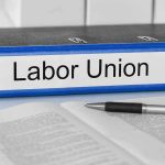 $50 Million Teachers Union Scandal — Radical Agendas Financed! Blue binder labeled Labor Union beside papers and pen.