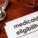 Massive Cuts to Medicaid Could be Coming Stethoscope pen document about Medicaid eligibility on table