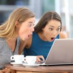 Caffeine’s Dark Side: Brewing Dangerous Bacteria? Two women surprised while looking at a laptop.