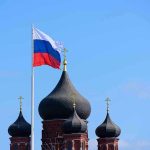 Russian Prosecutors Target US Ex-Marine Russian flag next to church domes