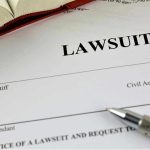 Music Icon SUED—Bandmates Demand Millions Lawsuit document with a pen and book.