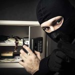 Midwest Mom’s Brave Stand Against Intruder A masked burglar holding a gun while attempting to open a safe