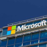 Elon Musk vs Bill Gates: Battle of the Century? Microsoft logo on a modern corporate building against a blue sky
