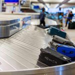 Drones Paralyze Europe’s Busiest Airport AGAIN! Luggage on airport baggage claim conveyor belt.