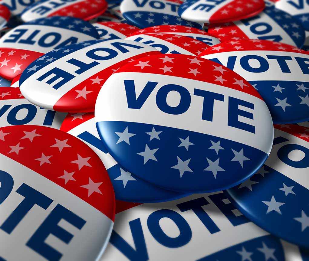 Shock Accusation—Governor STIRS Mid-Terms Controversy! A pile of colorful buttons with the word VOTE and stars, symbolizing election participation