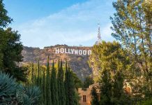 Actor SLAMS Tump Live—Crowd Goes Nuts Hollywood sign on hill surrounded by trees and buildings.