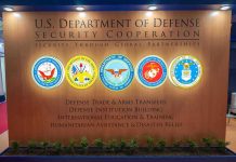 Generals Told to Prepare for War – DECLARATION! U.S. Department of Defense Security Cooperation display with logos.