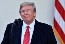 Trump CHARMS Leader – Secures Massive Deal! Man in suit and tie speaking at podium.