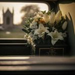 Billionaire CEO DIES In DISASTROUS ATV Accident White flowers in a car with blurred background.