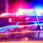 Mayor Stabbed at Home—Daughter In Custody! Police car lights flashing at night.