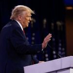 Trump Revives 50-Year Law – Billions SLASHED! Person speaking at a podium with hand raised