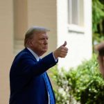 Trump Frees Felon—Congress ERUPTS Overnight Man in suit giving thumbs up.