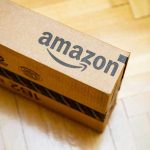 Amazon Faces UNPRECEDENTED Worker Revolt Amazon package on wooden floor