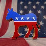 A donkey symbol representing the Democratic Party in front of an American flag background
