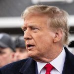 Department of Education VANISHES – Trump Signs Off Man in suit and red tie speaking outside.