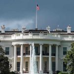 Trump, Mamdani MEET – Exchanges Tense First Words White House with American flag and fountain, stormy sky.