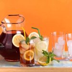 Brain-Boosting Drinks: A Game Changer for Dementia? A pitcher of iced tea with lemon slices and mint, alongside glasses with ice and colorful straws