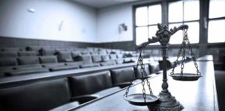 Scales of justice in an empty courtroom.