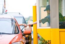 Government Decides How Citizens Should Eat Takeout Customer receiving a food order at a drive-thru window