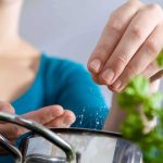 FDA Warning: Toxic Cookware INVADES American Kitchens Person seasoning food with herbs from a pot