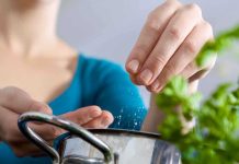 FDA Warning: Toxic Cookware INVADES American Kitchens Person seasoning food with herbs from a pot