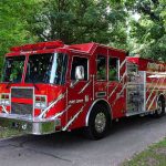 Firefighter SCANDAL Erupts: Baltimore in Shock A red fire truck parked in a green park