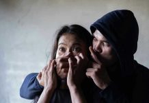 TERRIFYING Abduction Caught on Camera — Cartel War Man holding womans mouth, gesturing silence.