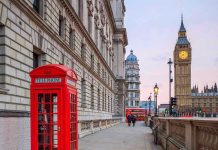 Red telephone booth near Big Ben in London.