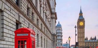 Red telephone booth near Big Ben in London.