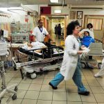 Medical staff attending to patients in a busy hospital emergency room