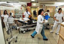 Medical staff attending to patients in a busy hospital emergency room