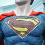 Close-up of a Superman statue wearing a blue costume and red cape