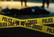 Felon MURDERS Girlfriend — Confesses She “Deserved It” Police tape marking a crime scene at night.