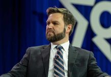 VP Vance’s Holocaust Post Triggers FURY Man in a suit with a thoughtful expression.