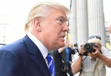 Dad Shoots Daughter Over Trump Fight Man in suit with photographers in background.