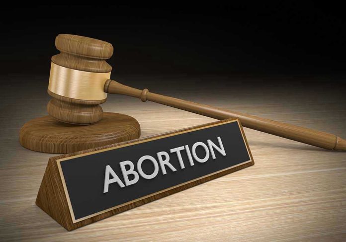 317138369 Gavel and sign reading Abortion on a wooden surface.