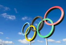 Olympic Gold STOLEN — French Judge Exposed Olympic rings sculpture against blue sky.