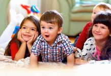Child Care Trap Demands $400K Salary A group of children enjoying playtime indoors, displaying joyful expressions