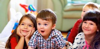 A group of children enjoying playtime indoors, displaying joyful expressions